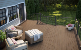 Outdoor deck space with two chairs featuring Vista Decking in Dunewood and Contemporary Cable Rail