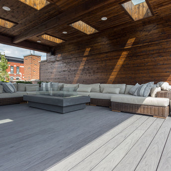 Rooftop deck with couch built by Unique Deck Builders using Deckorators composite decking