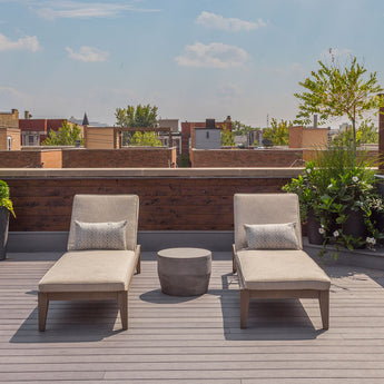 Rooftop deck with lounge chairs built by Unique Deck Builders using Deckorators composite decking